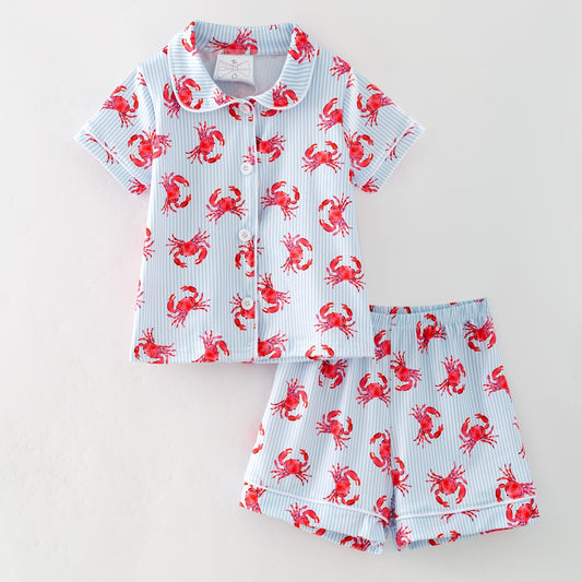 Children's shirt and shorts set with red crab pattern on a light blue background