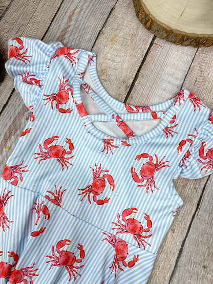 Dress with red crab pattern on a wooden background