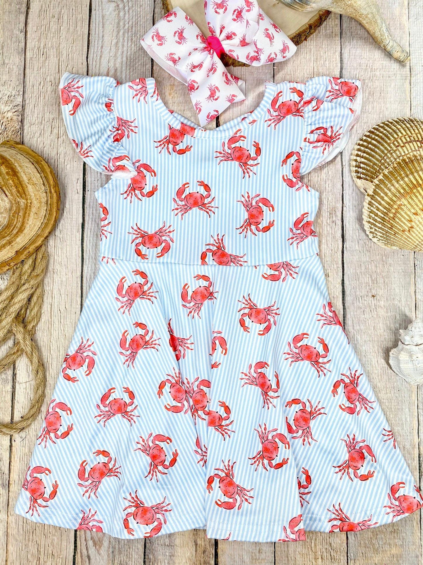 Dress with red crab pattern on a wooden background