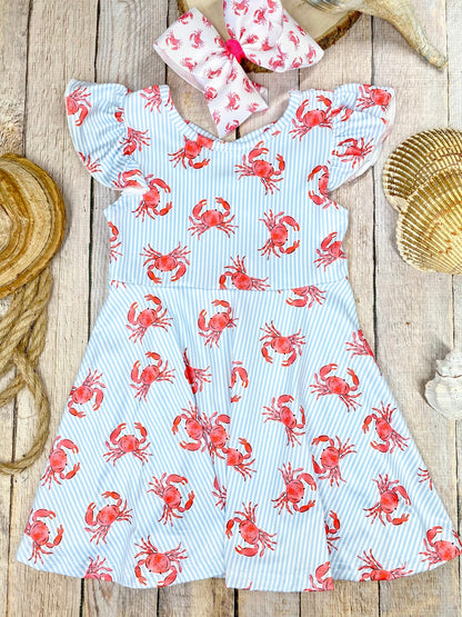 Dress with red crab pattern on a wooden background