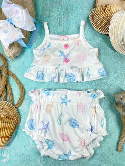 Children's two-piece romper with shell and starfish pattern on a blue background