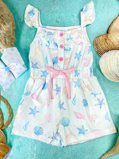 Children's romper with sea-themed print on a blue background