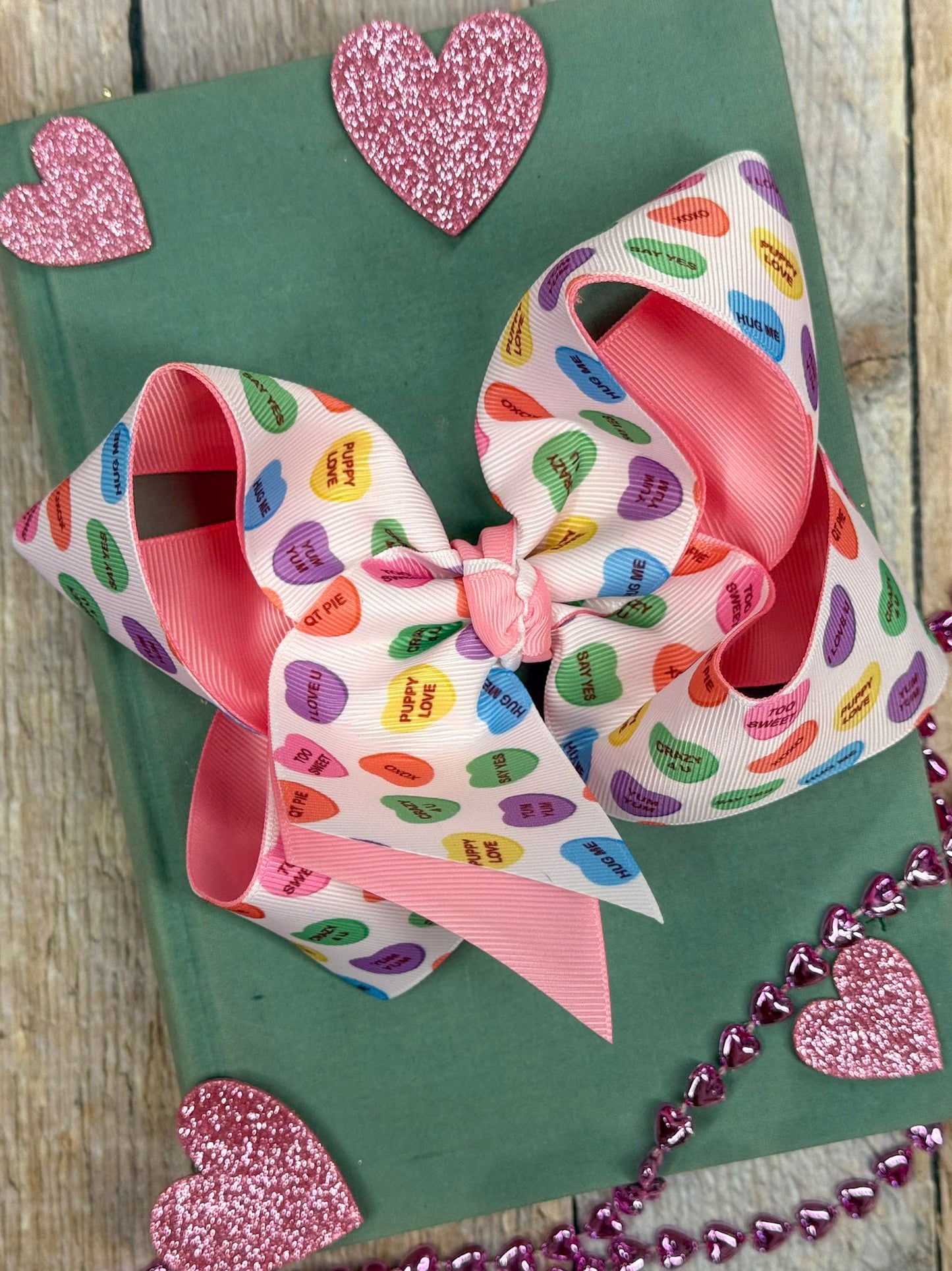 conversation heart bow on green book