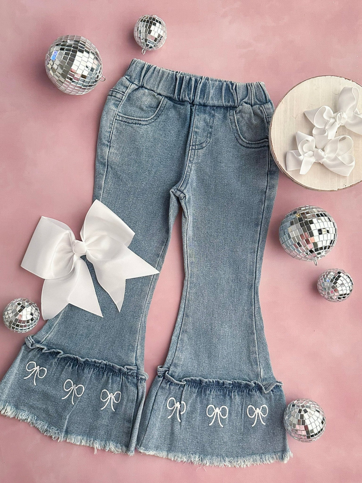 Bell bottom jeans with coquette bow trim