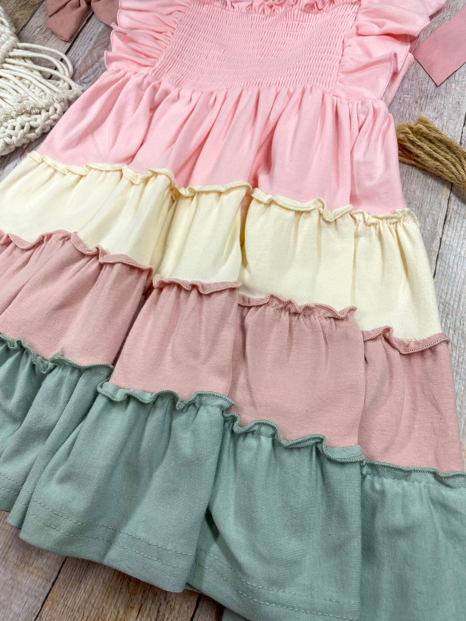 Colorful tiered dress with ruffled details on a wooden background