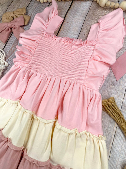 Colorful tiered dress with ruffled details on a wooden background
