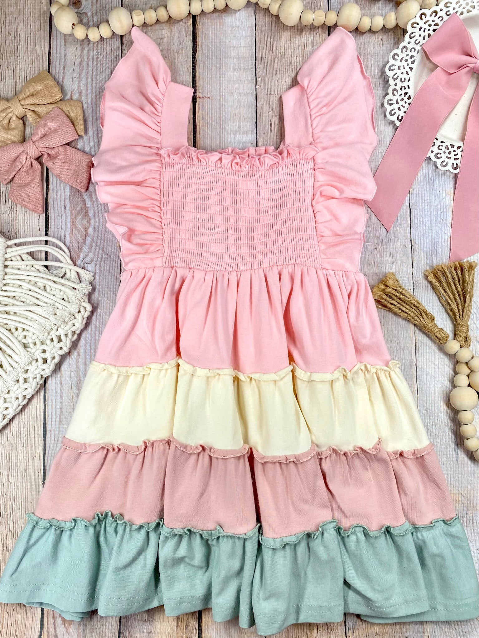Colorful tiered dress with ruffled details on a wooden background