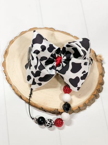 Black and white cow print Texas size knot hair bow with red center