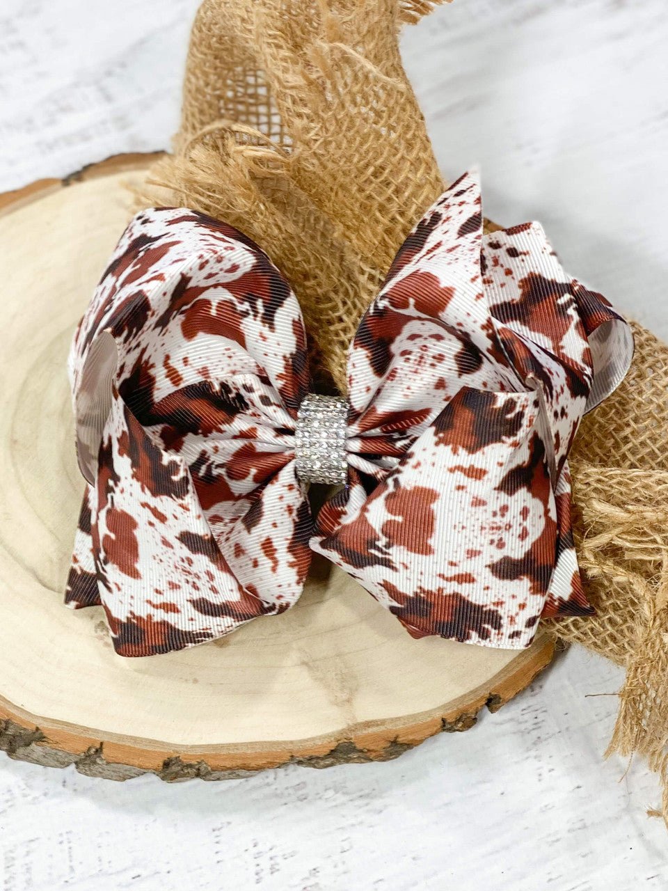 Brown, black and white cowhide print Texas size hair bow with rhinestone center