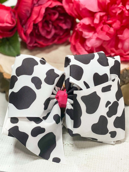 Cow print Texas size hair bow with pink center