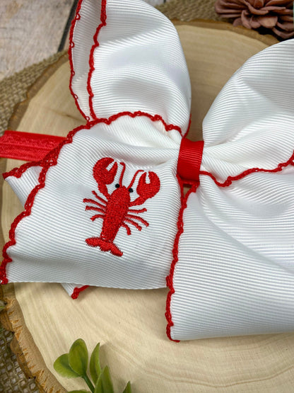 The Crawfish & Lobster Embroidered Moonstitch Headband on a wooden background