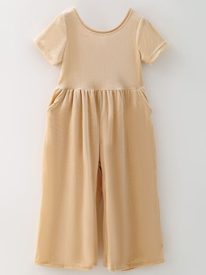 Ivory girls’ velvet wide-leg jumpsuit with short sleeves and side pockets.