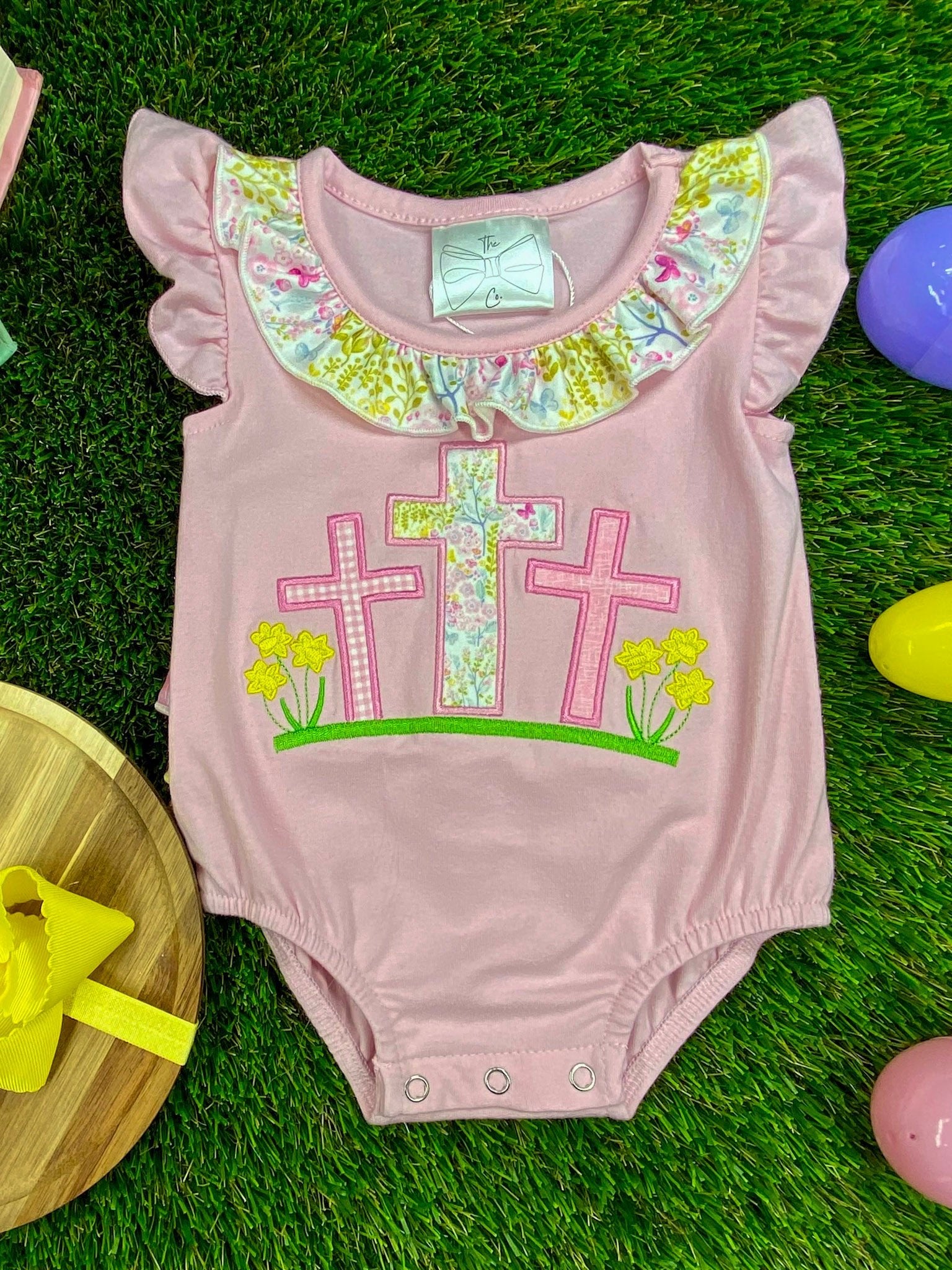 Cross infant easter romper on grass
