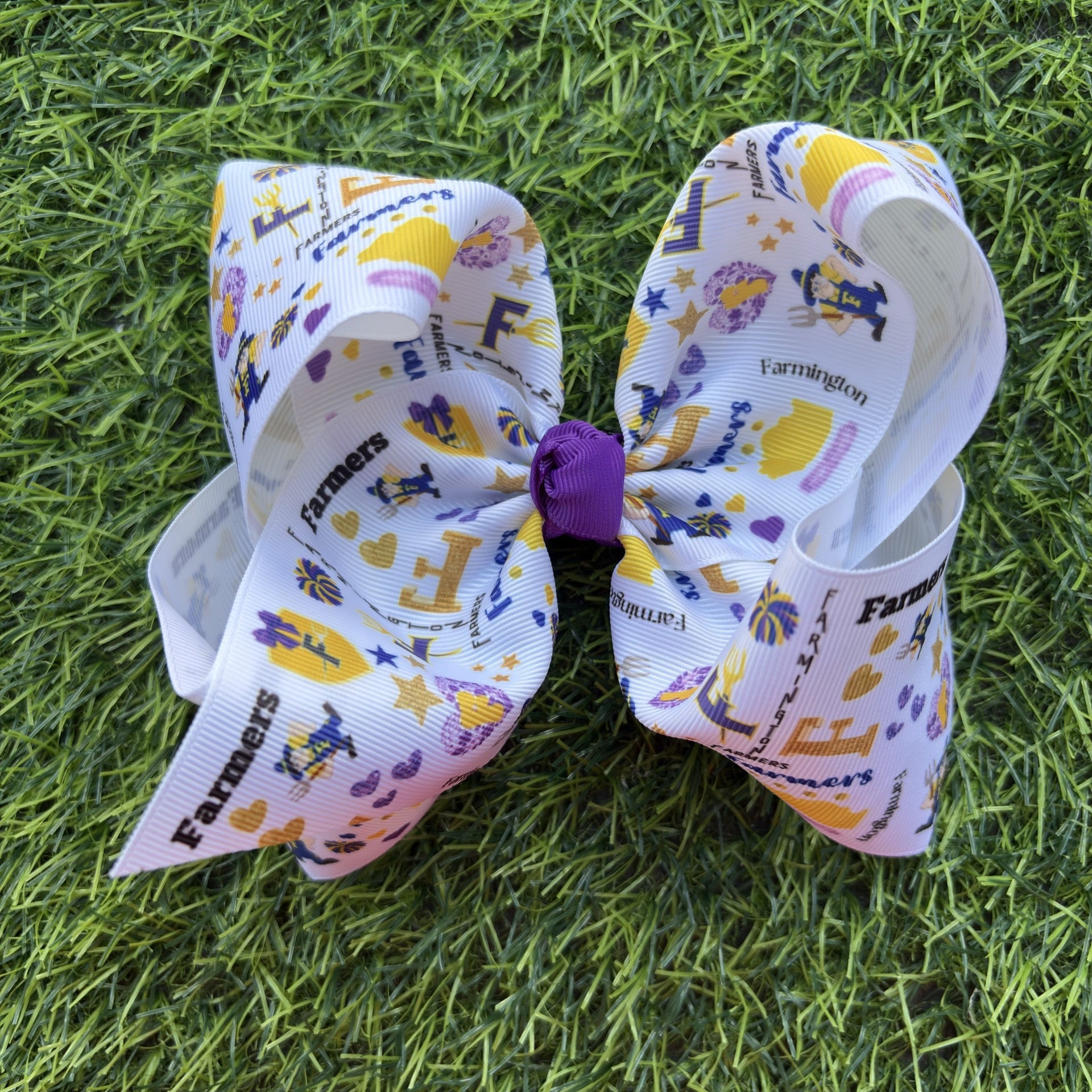 Large decorative bow with 'Farmington' branding on a grass background