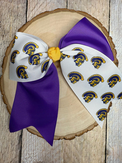 Purple and white custom printed cheer bow on a wooden background