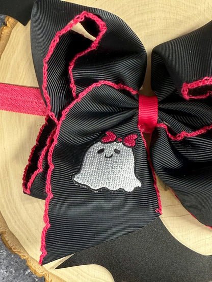Close up of ghost embroidery and hot pink moonstitch detail on headband