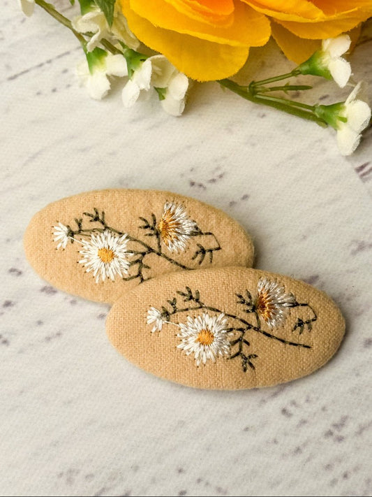 Set of 2 daisy embroidered clippies.
