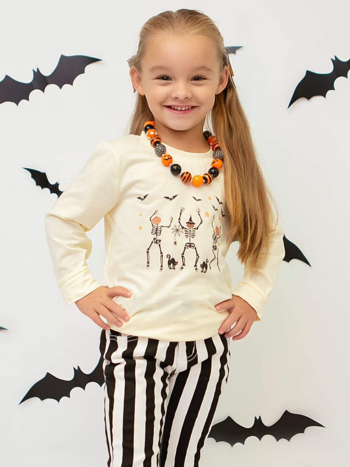 Girl wearing the dancing skeletons long sleeve shirt