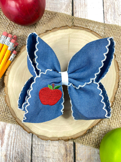 Denim Apple Embroidered Moonstitch Hair Bow on a wooden background
