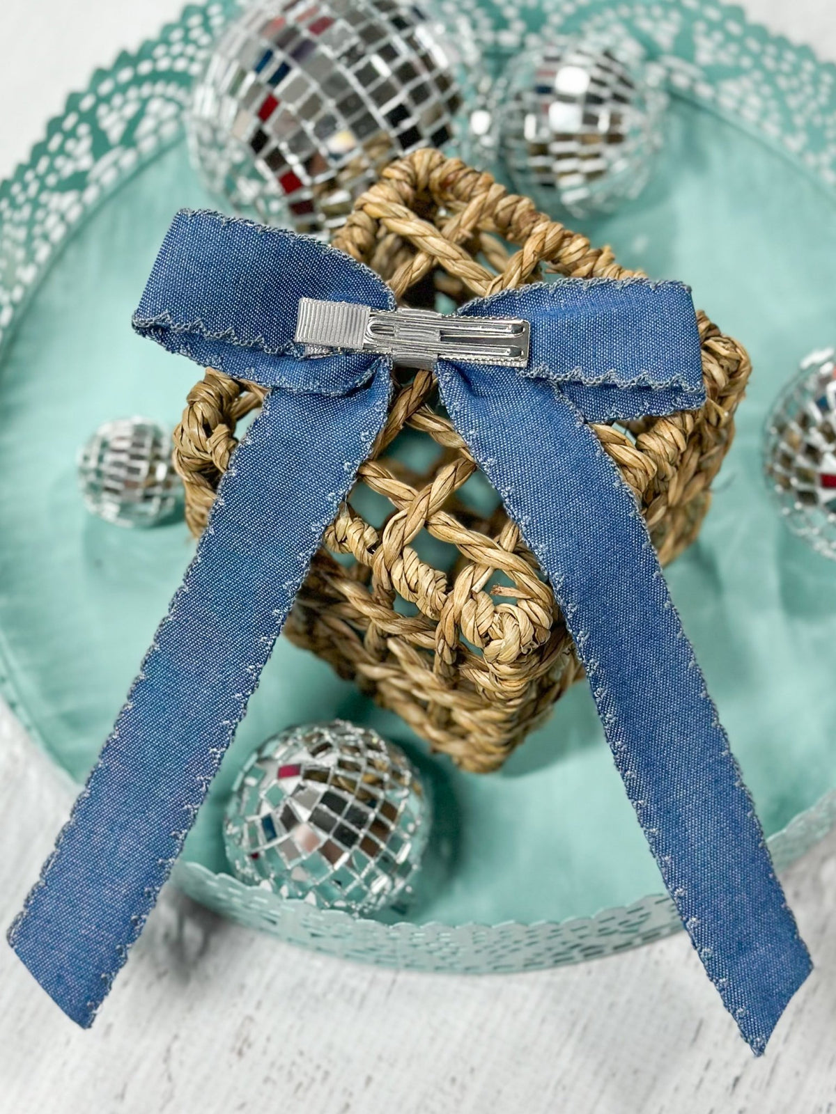 Back of denim ruffle edge hair bow showing alligator clip