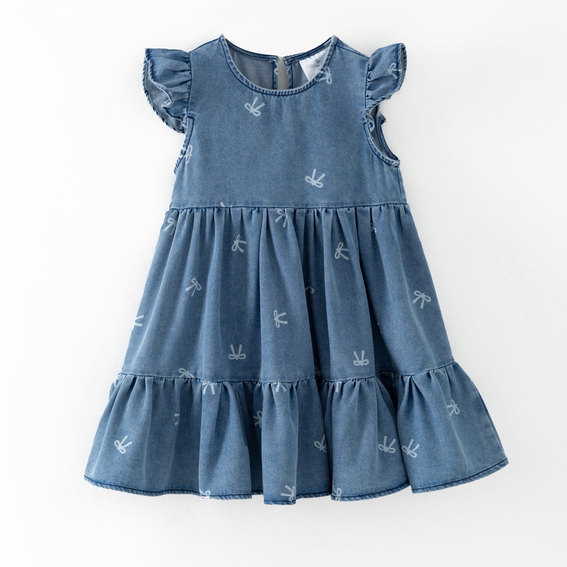 Blue denim bow print dress with ruffled sleeves and bottom on a white background