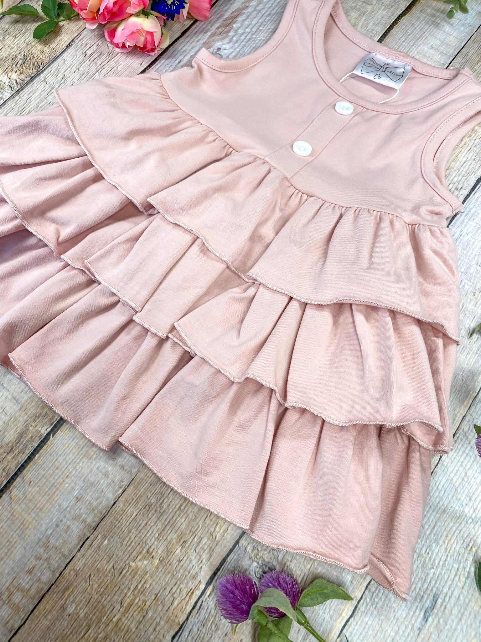 Pink tiered top on a wooden background