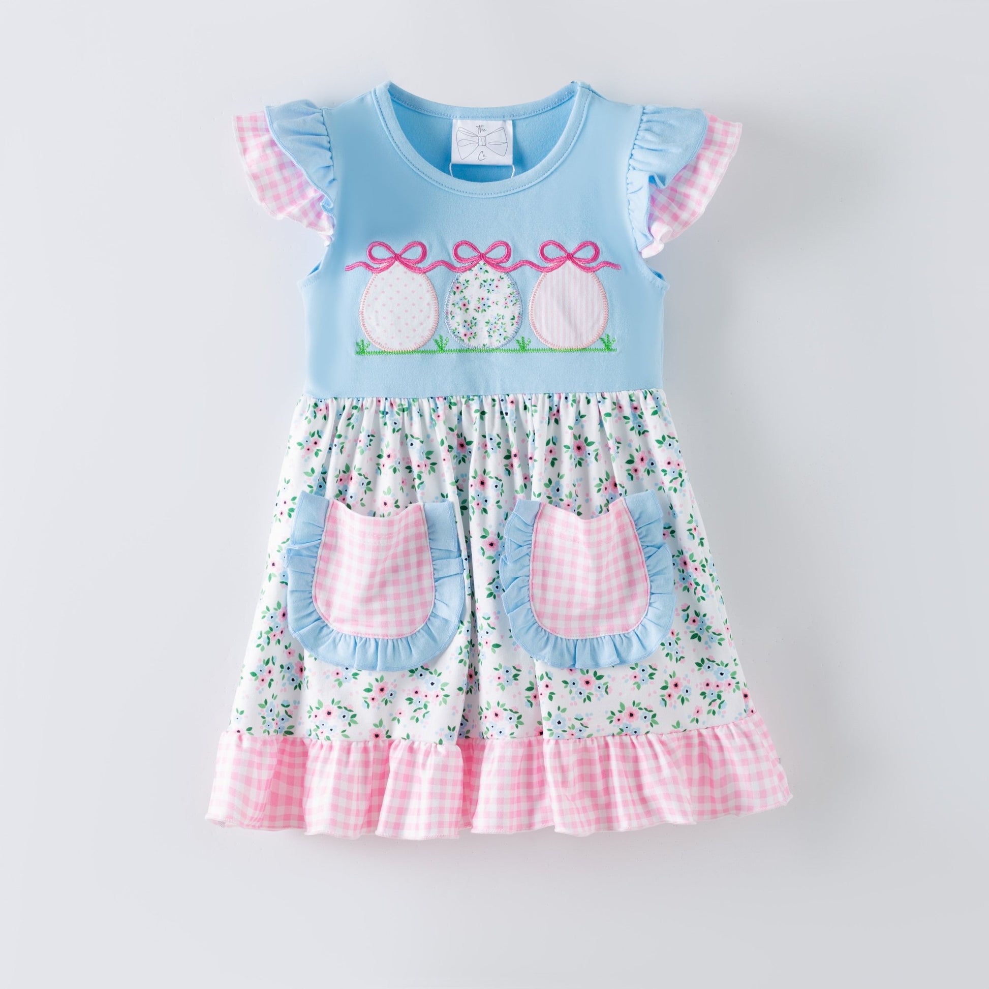 Girls blue Easter dress with embroidered Easter eggs, floral skirt, gingham ruffle hem and pockets, boutique spring dress