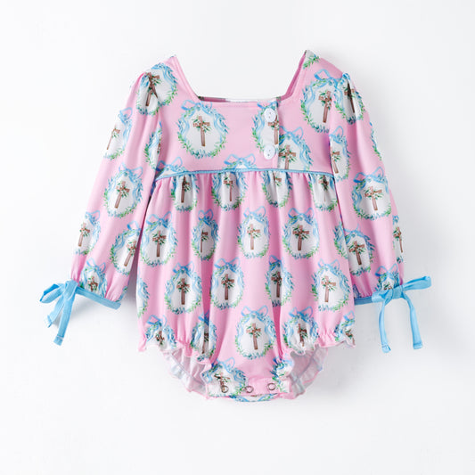 Baby girl pink Easter romper with blue cross wreath print, long sleeves with bow ties, snap closure, boutique Easter outfit