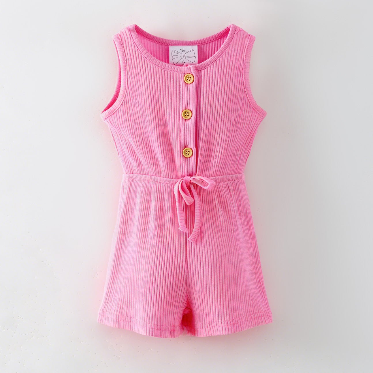 Pink romper with buttons on a light gray background
