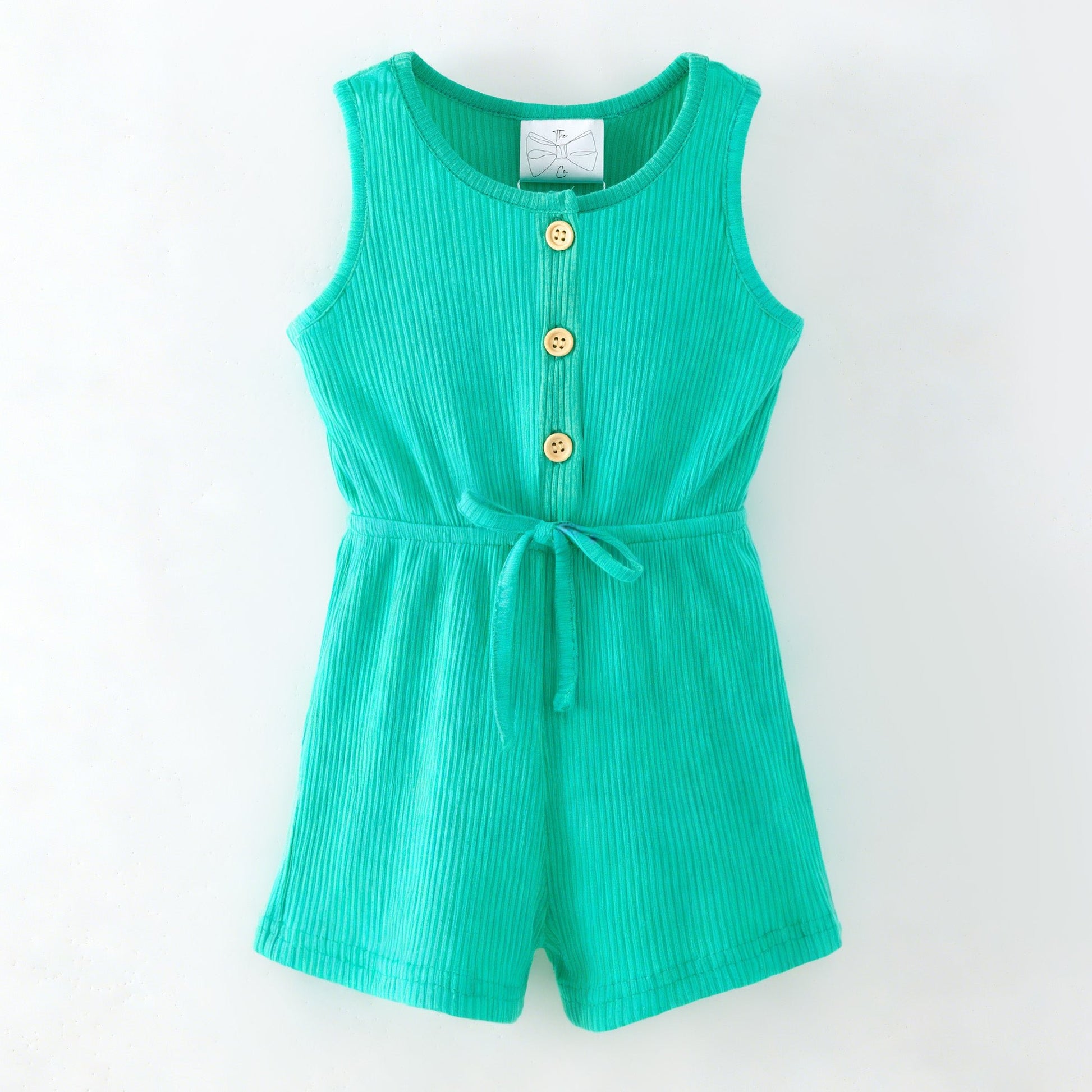 Green romper with button details on a white background