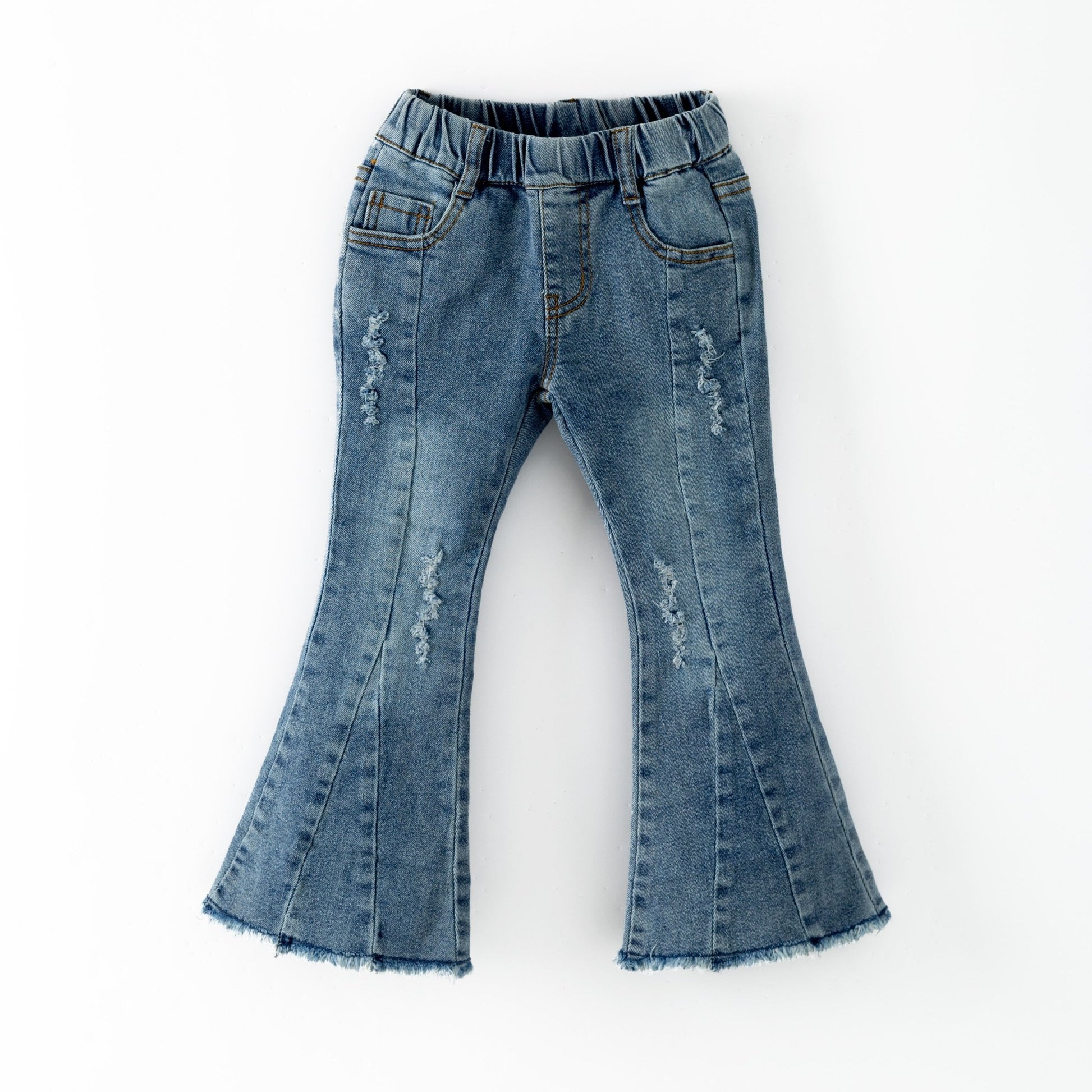 Pair of blue denim bell-bottom pants on a white background