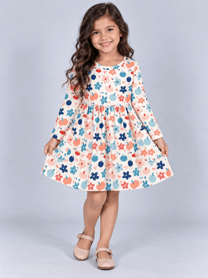 model wearing our Girls fall pumpkin floral pocket dress on grey backdrop