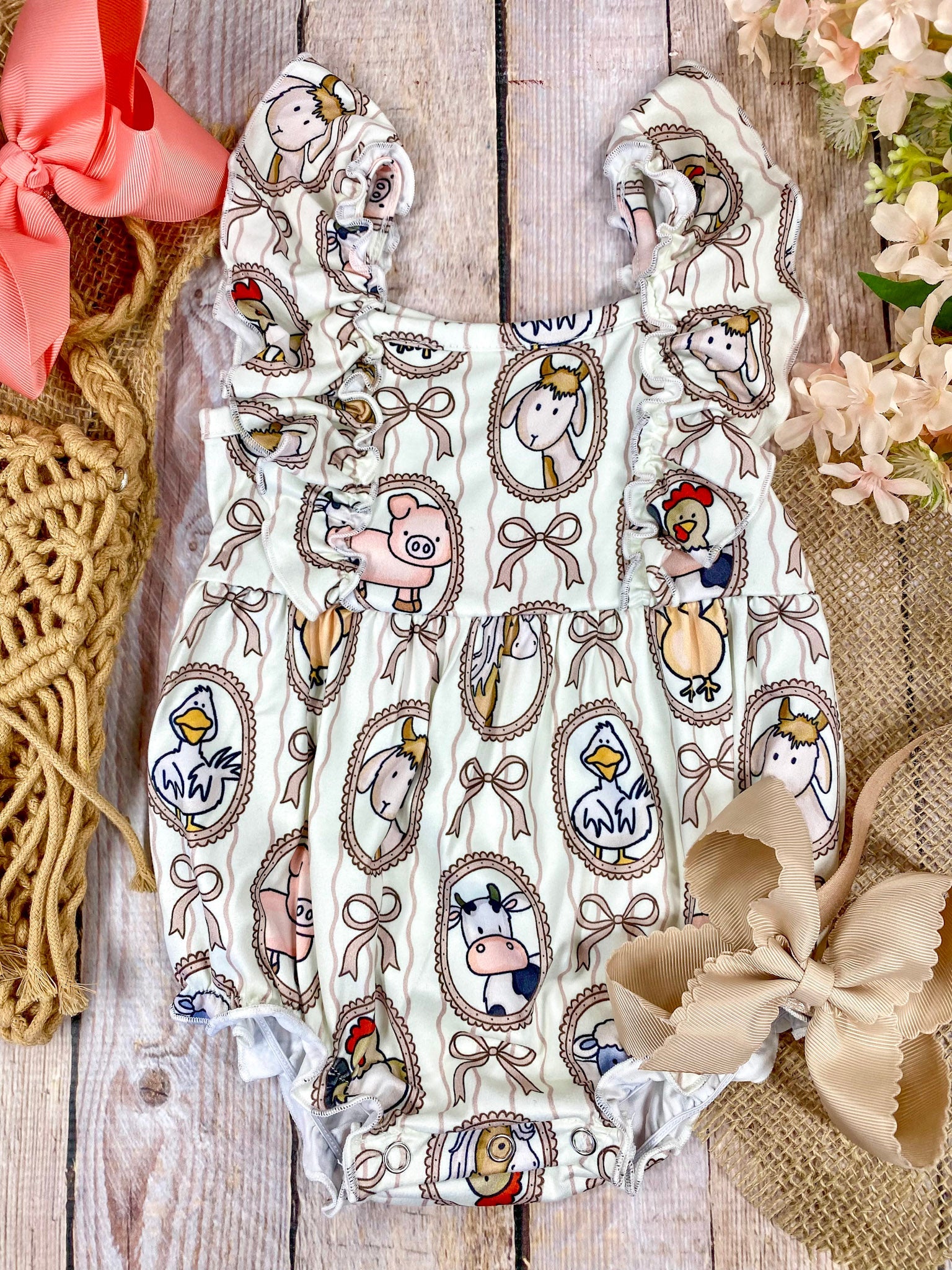 Farm animal baby boutique romper on wooden background