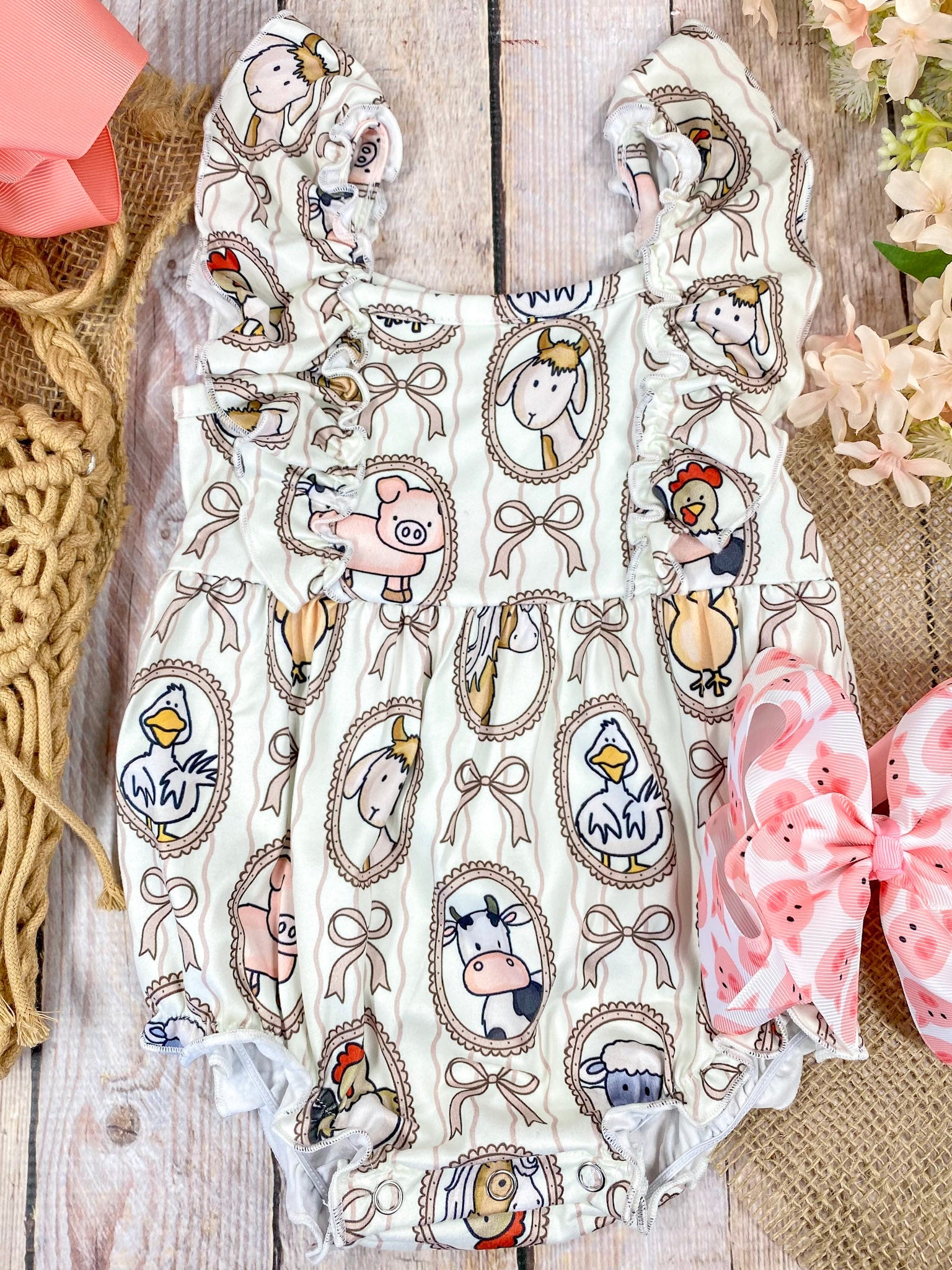 Farm animal baby boutique romper on wooden background