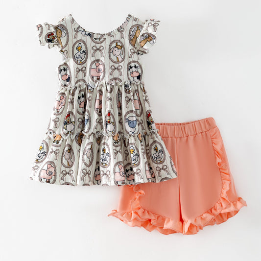 Children's outfit with patterned top and peach-colored shorts on a white background - Alternative view