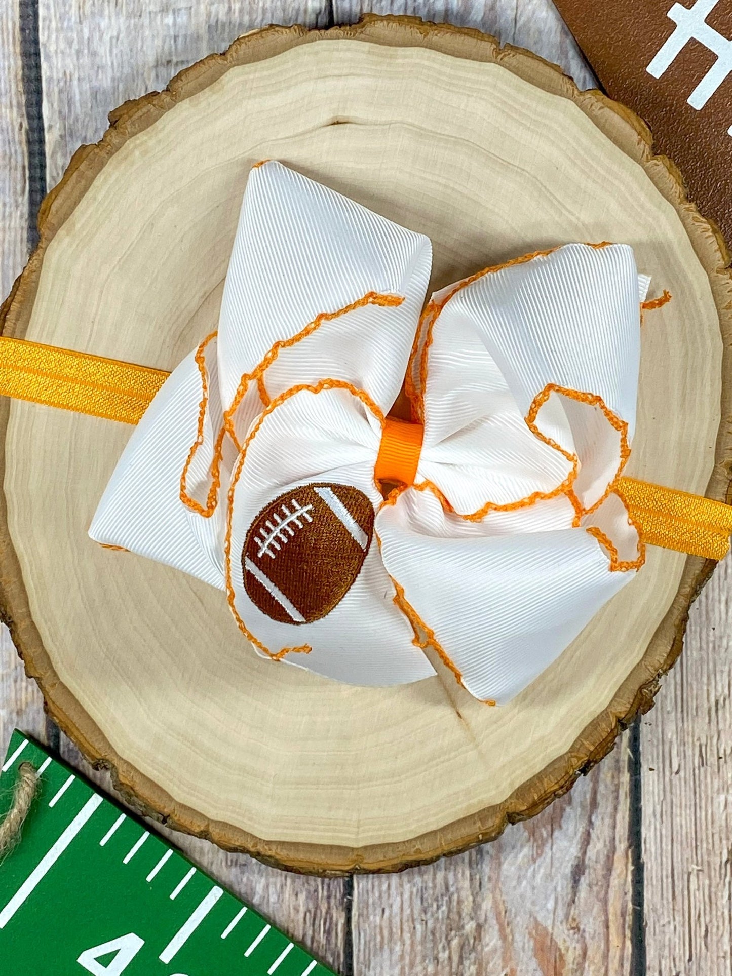 Football Embroidered Moonstitch Bow Headband with orange stitching