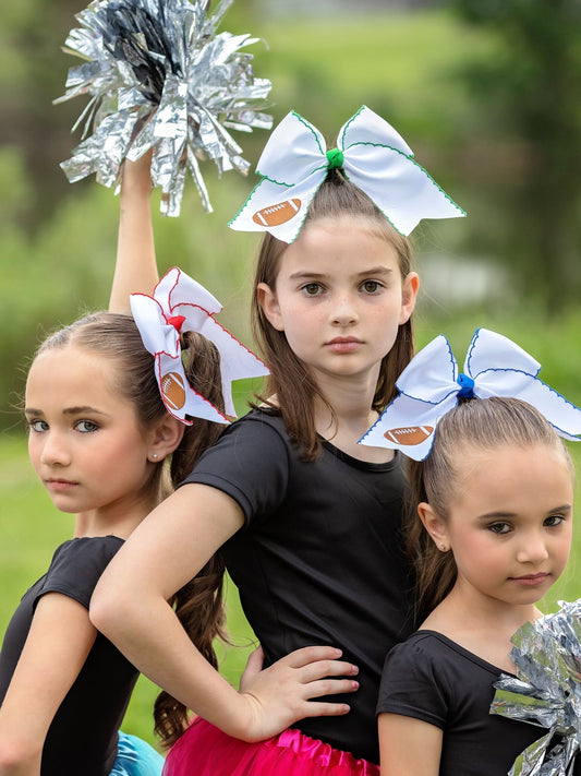 Girls wearing football embroidered moonstitch cheer bows