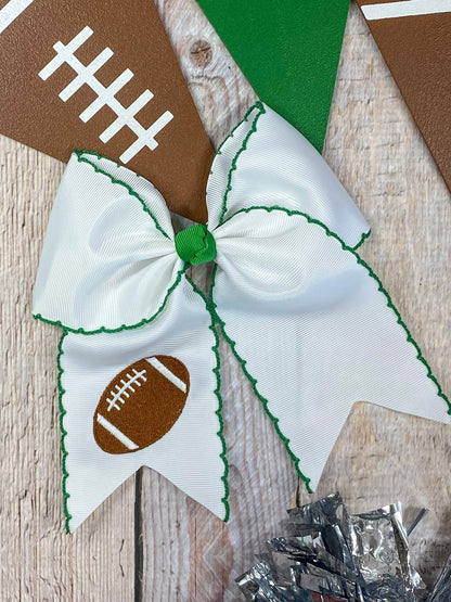 White football embroidered moonstitch cheer bow with green stitching
