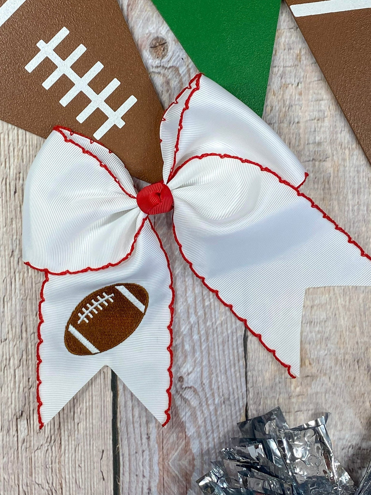 White football embroidered moonstitch cheer bow with red stitching