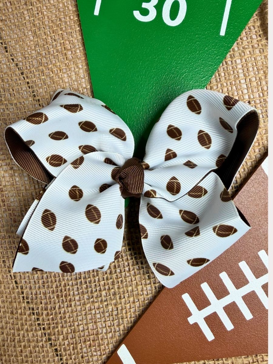 White and brown football print double layered hair bow styled for game day