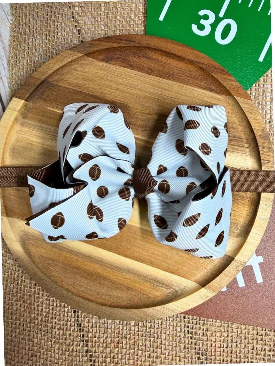 Girls football print double layered hair bow on a headband with brown trim for game day