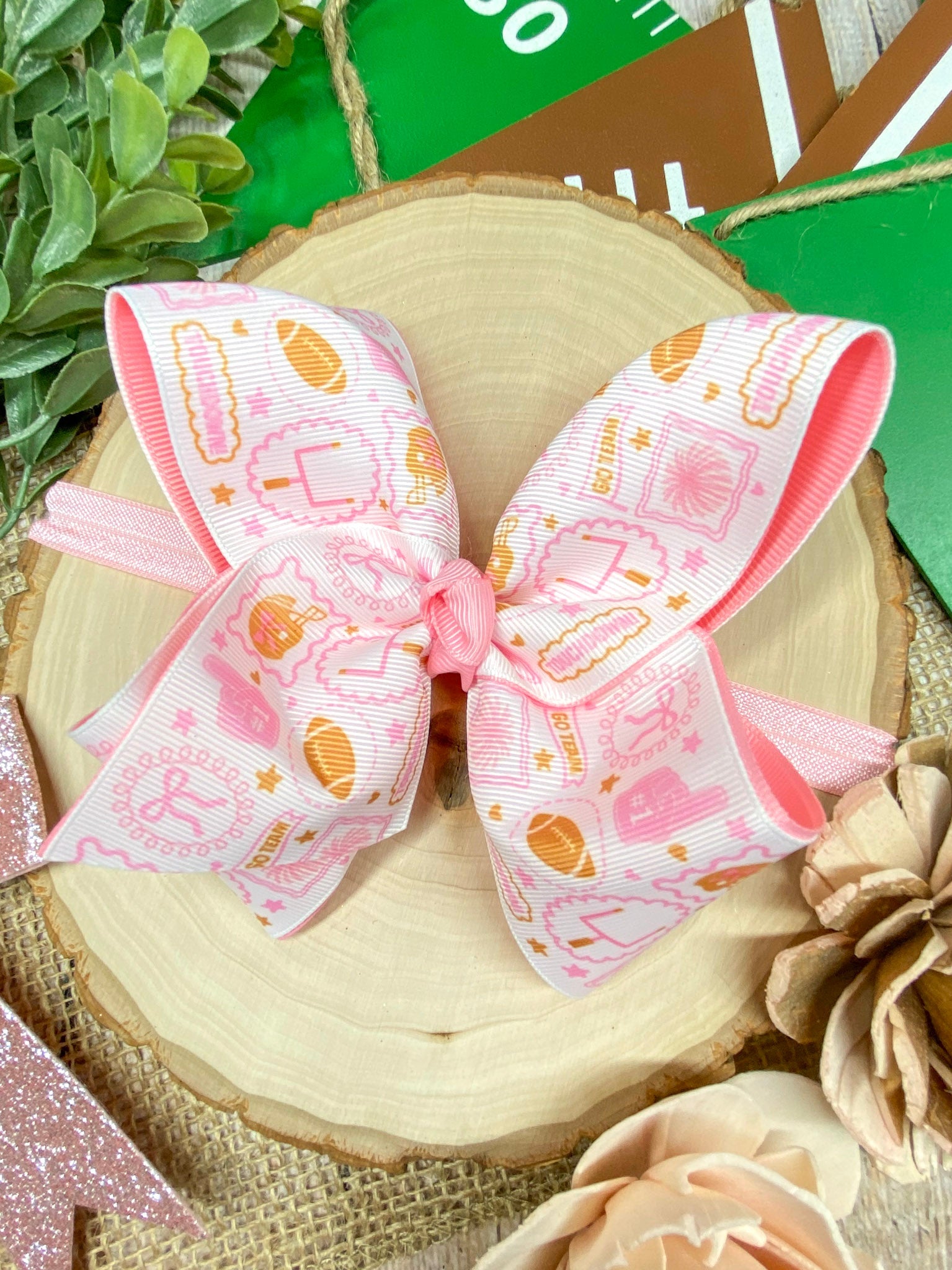 Football Print Pink Double Layer Headband on a wooden background