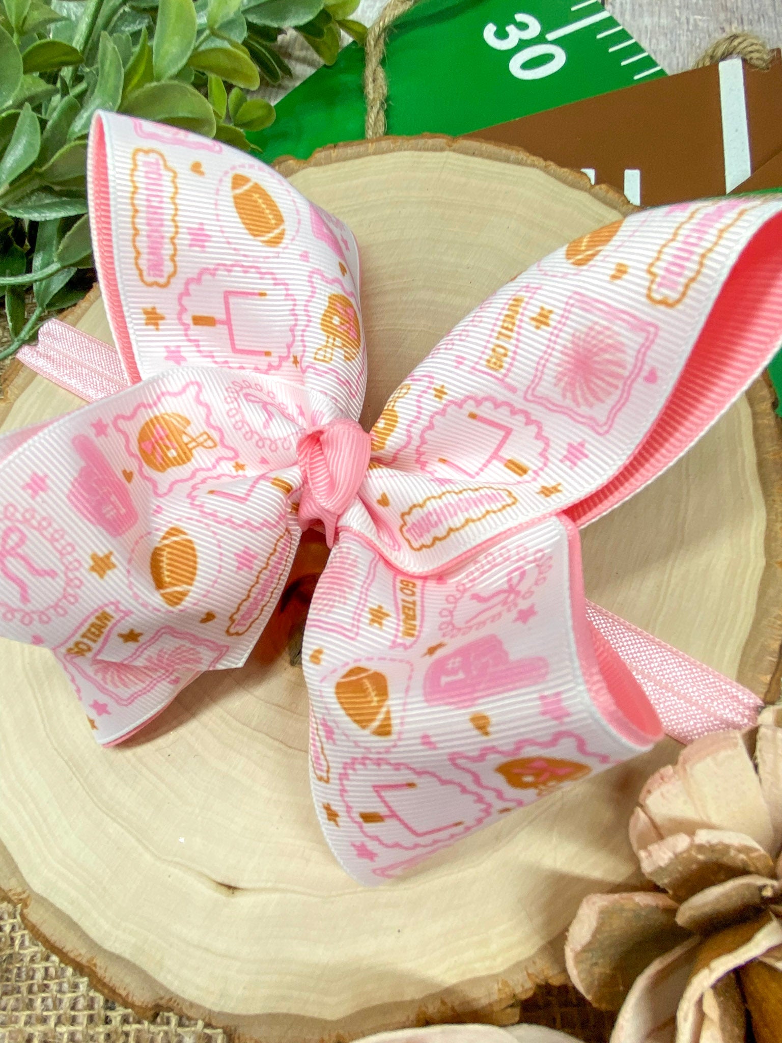 Football Print Pink Double Layer Headband on a wooden background