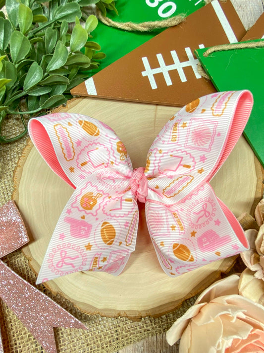 Football Print Pink Double Layer Hair Bow on a wooden background