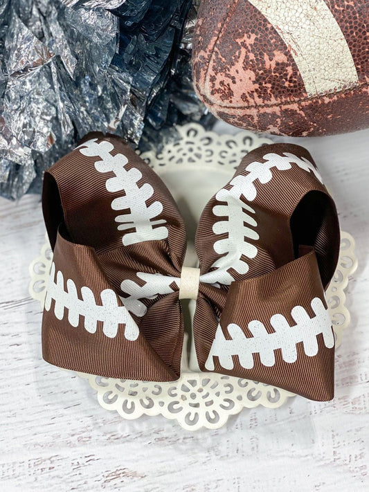 Football print Texas size hair bow on alligator clip