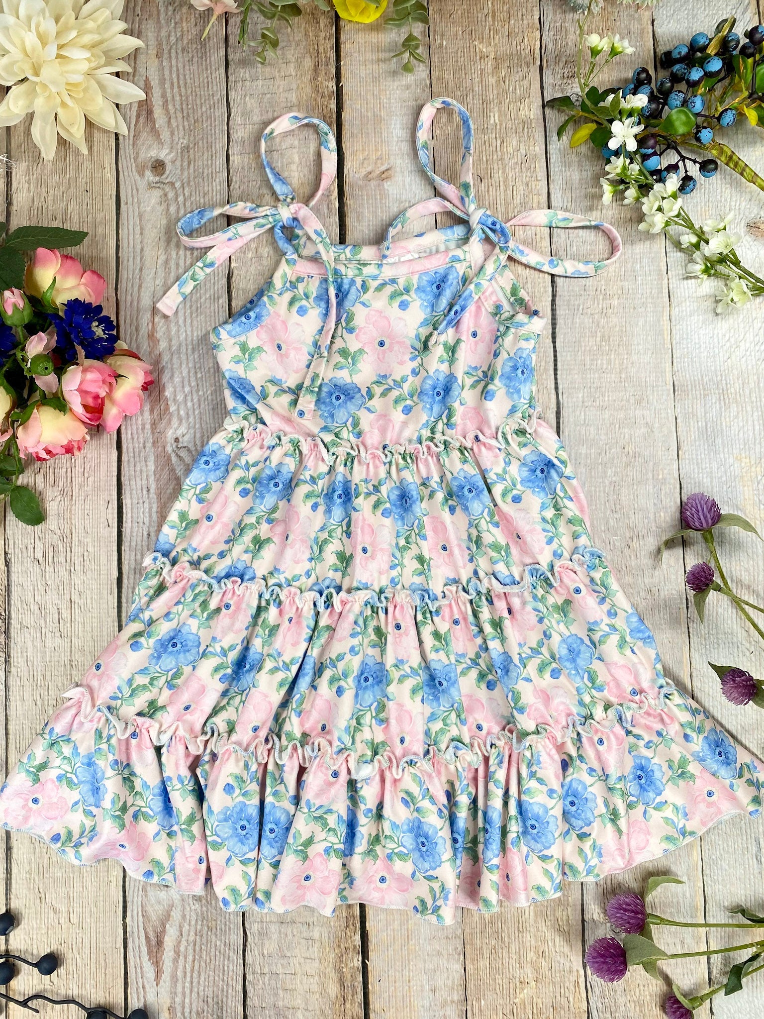 blue and pink Floral Tie Strap Tiered Dress for girls on a wooden background