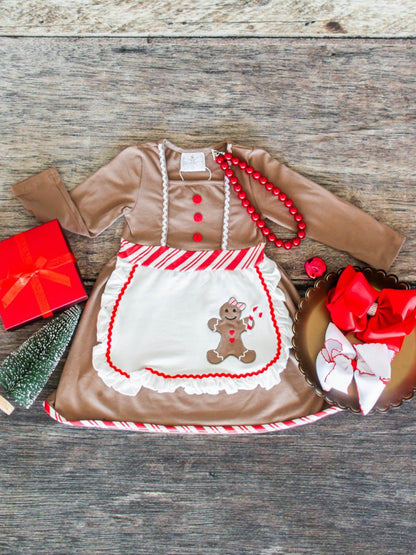 Children's dress with gingerbread design on a wooden surface