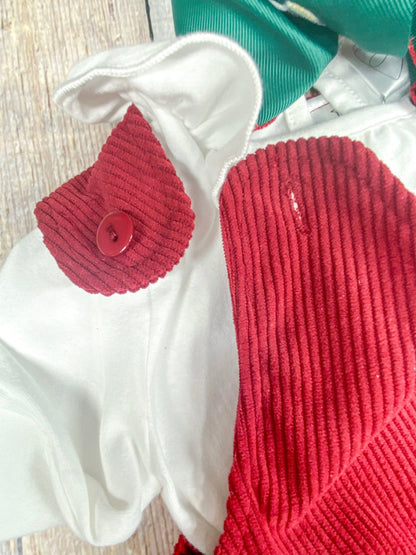 Close-up of the red corduroy jumper's unbuttoning shoulder