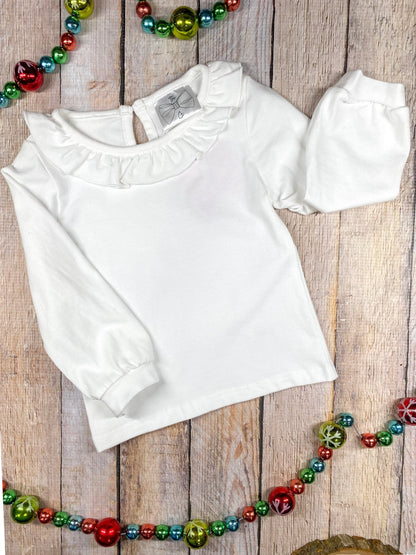 White ruffle collar long sleeve blouse worn under the gingerbread jumper