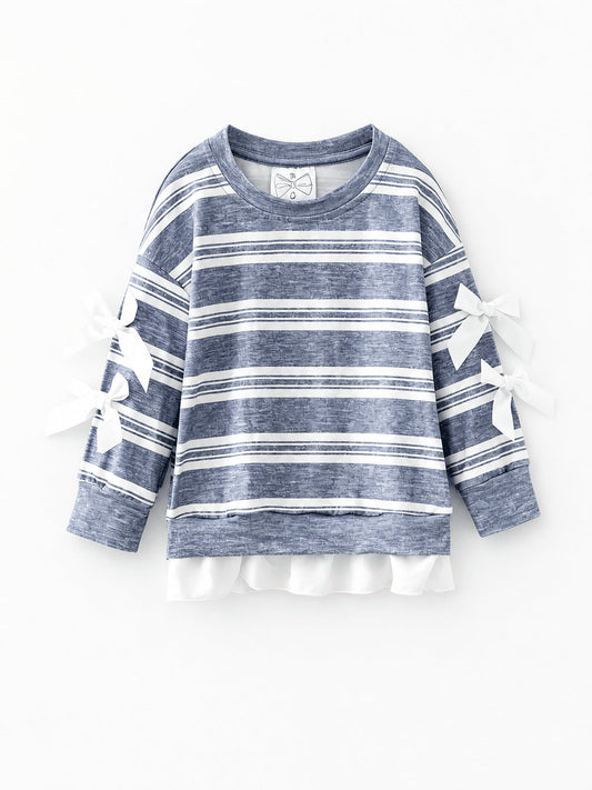 Blue striped top with white sleeve bows and a ruffle hem